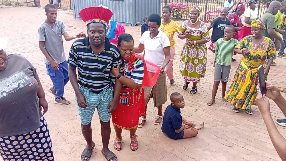 Residents and staff celebrating in traditional dress